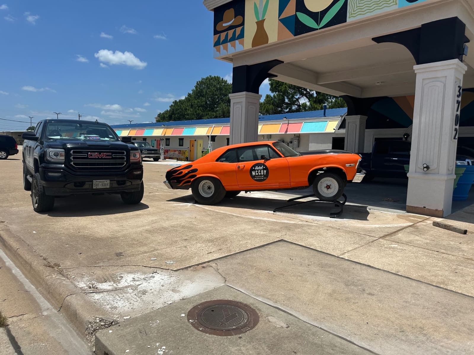 Hotel McCoy exterior entrance with colorful facade and vehicles