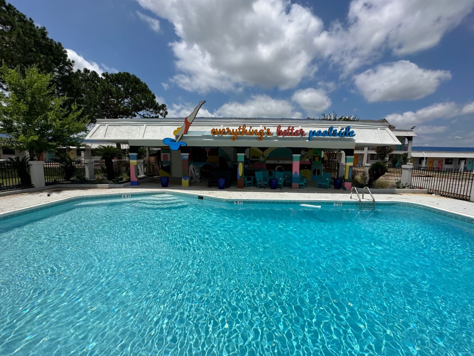 Poolside amenity area with colorful covered seating