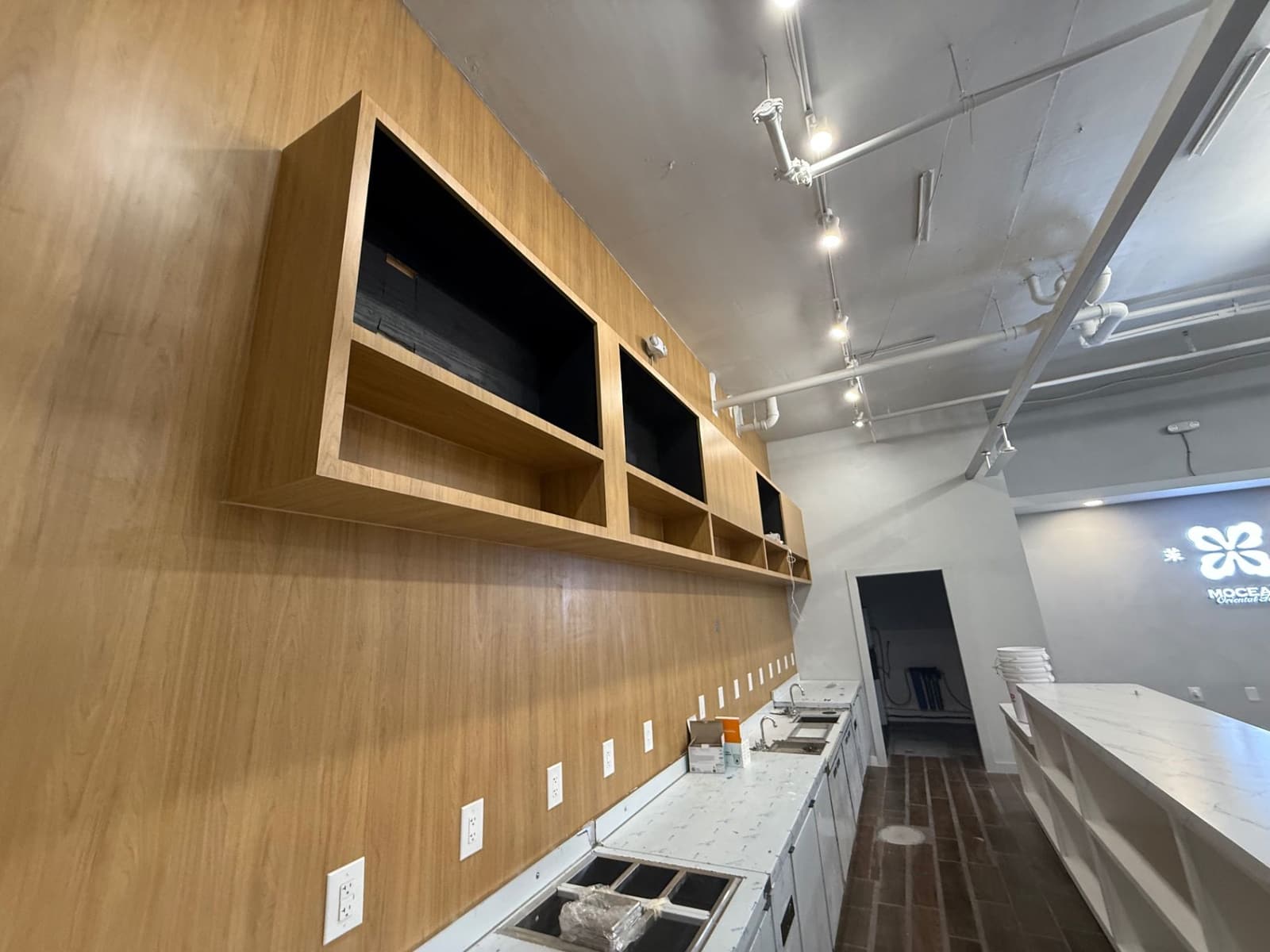 Close view of wood wall millwork and open display shelving