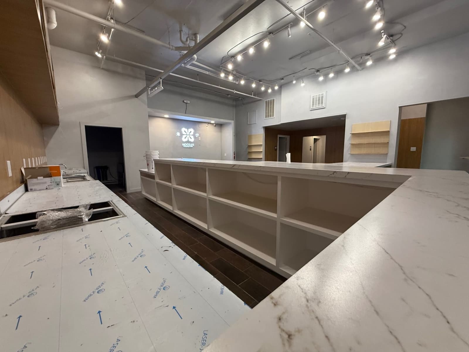 Commercial interior with protected countertop surfaces and open shelving