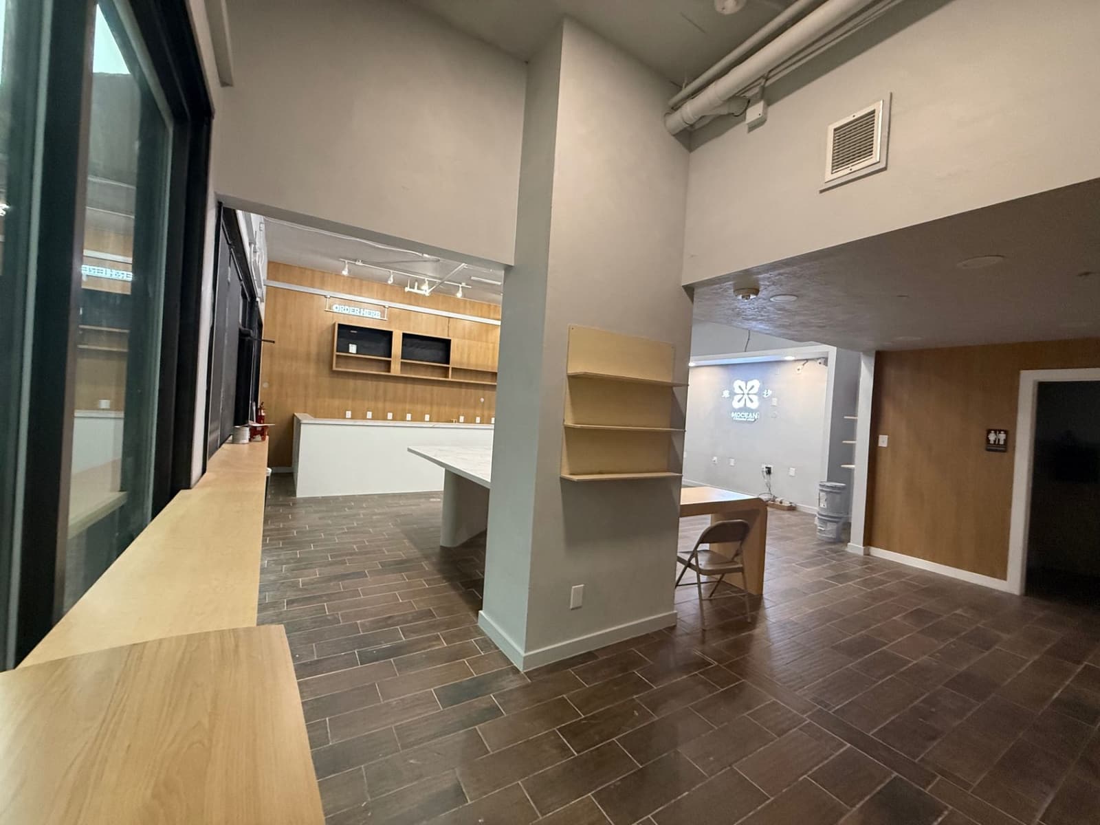 Commercial interior with window ledge, display shelving, and service counters